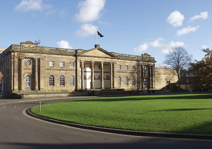 York Castle Museum, a historic building with columns at the entrance and a large lawn at the front.