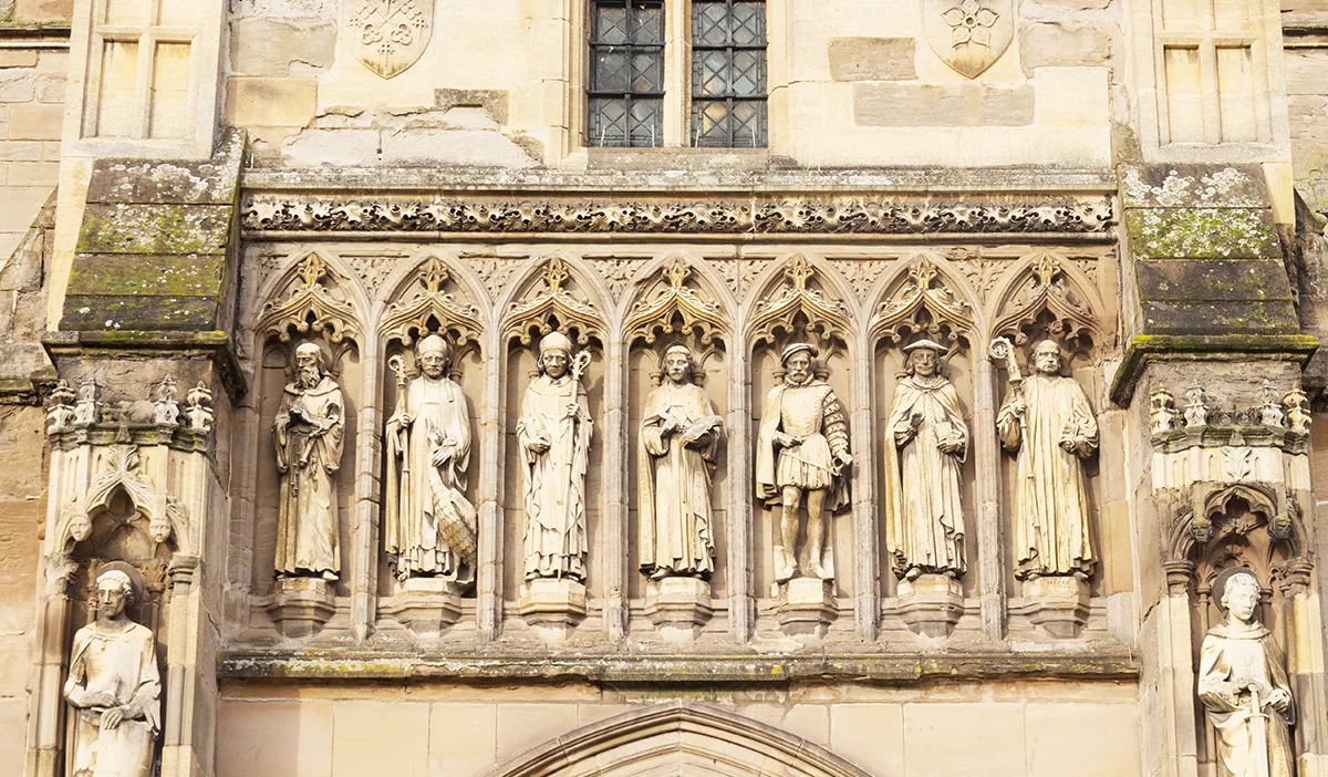 Statues of figures on the external wall of an ancient cathedral. 