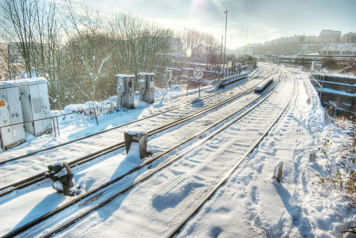 Railway tracks covered in snow and ice on a bright winter day