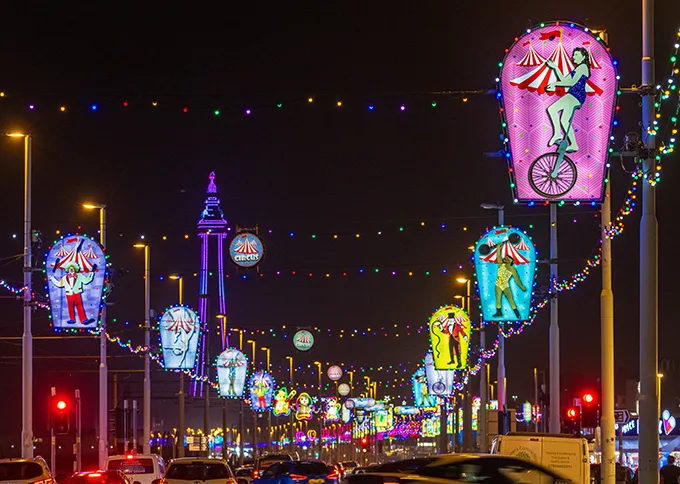 Blackpool's seafront promenade lit up by hundreds of bright neon lights.