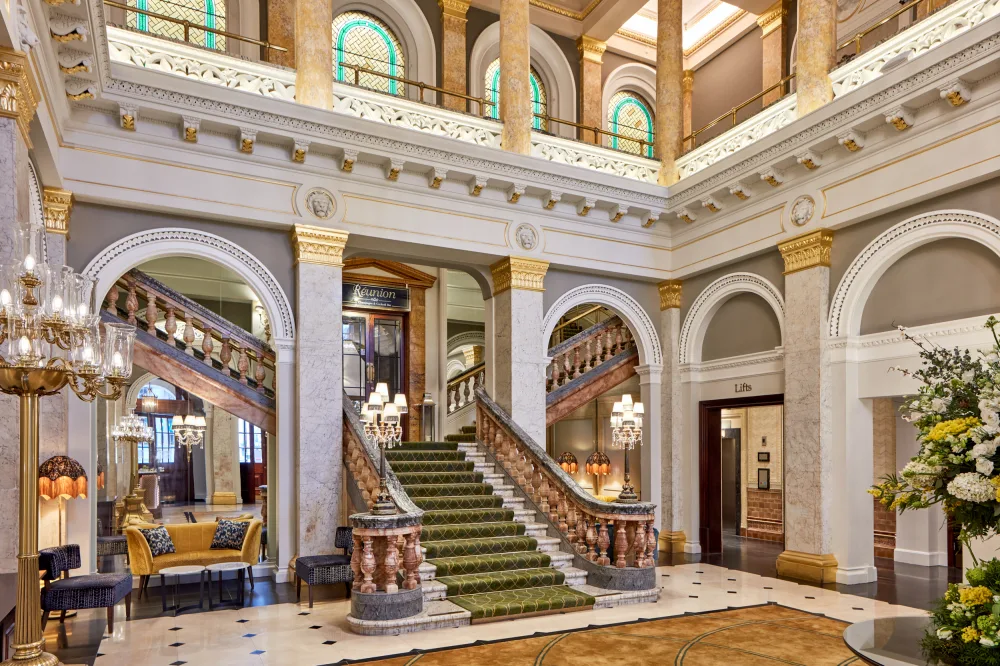A grand staircase in the lobby of a hotel.
