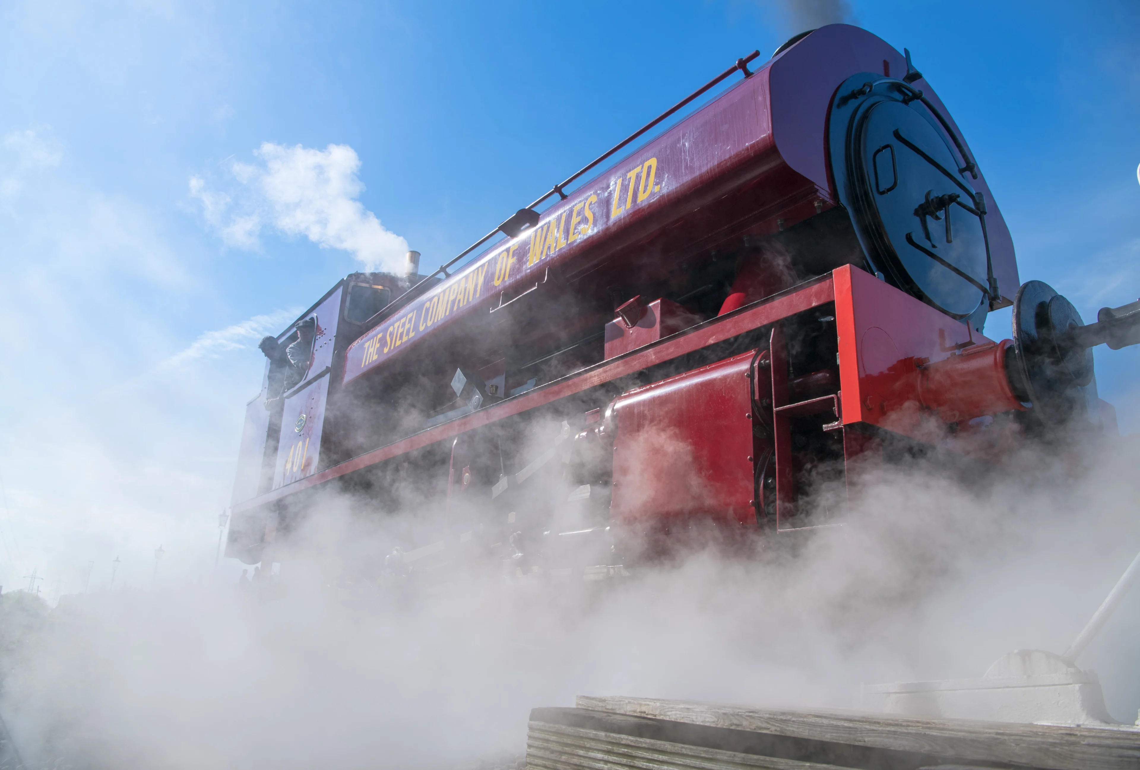 A red steam engine in motion