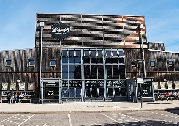 A wood and glass music venue with a sign saying CAMBRIDGE JUNCTION.