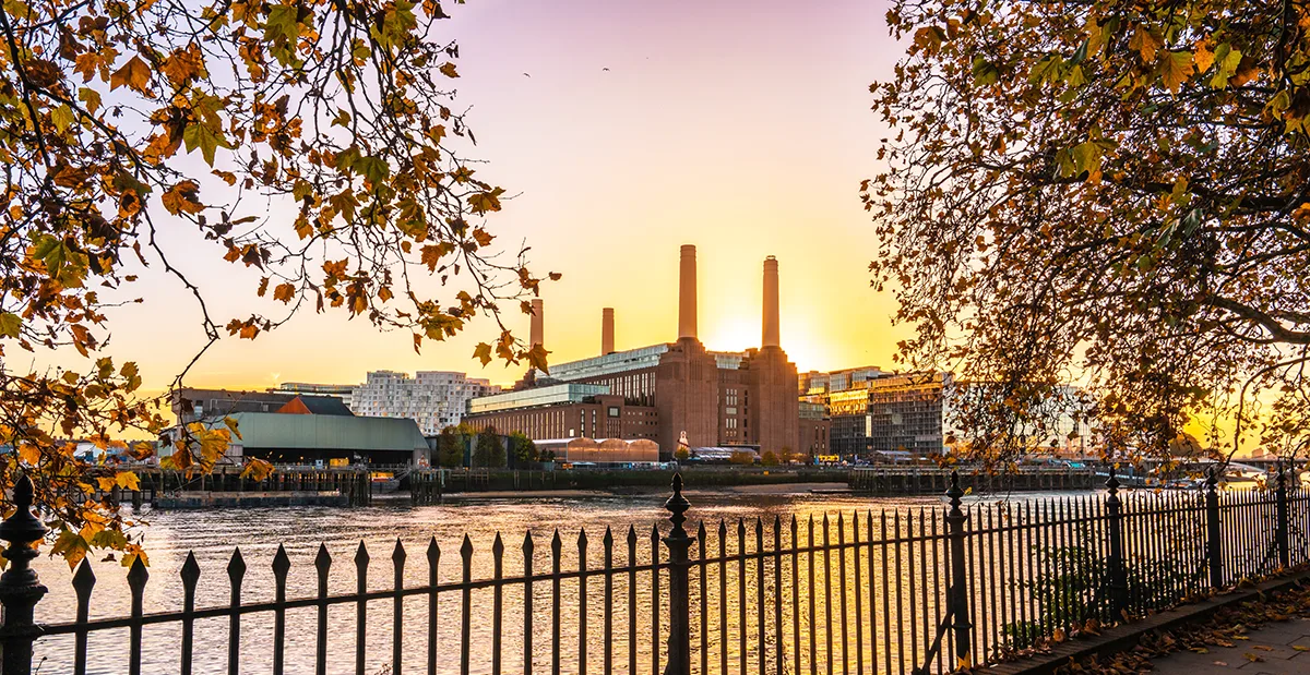 View across the River Thames towards Battersea Power Station on an autumn day. 