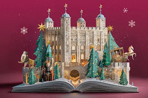 Festive pop-up book featuring the Tower of London with Christmas trees and decorations against a burgundy background.