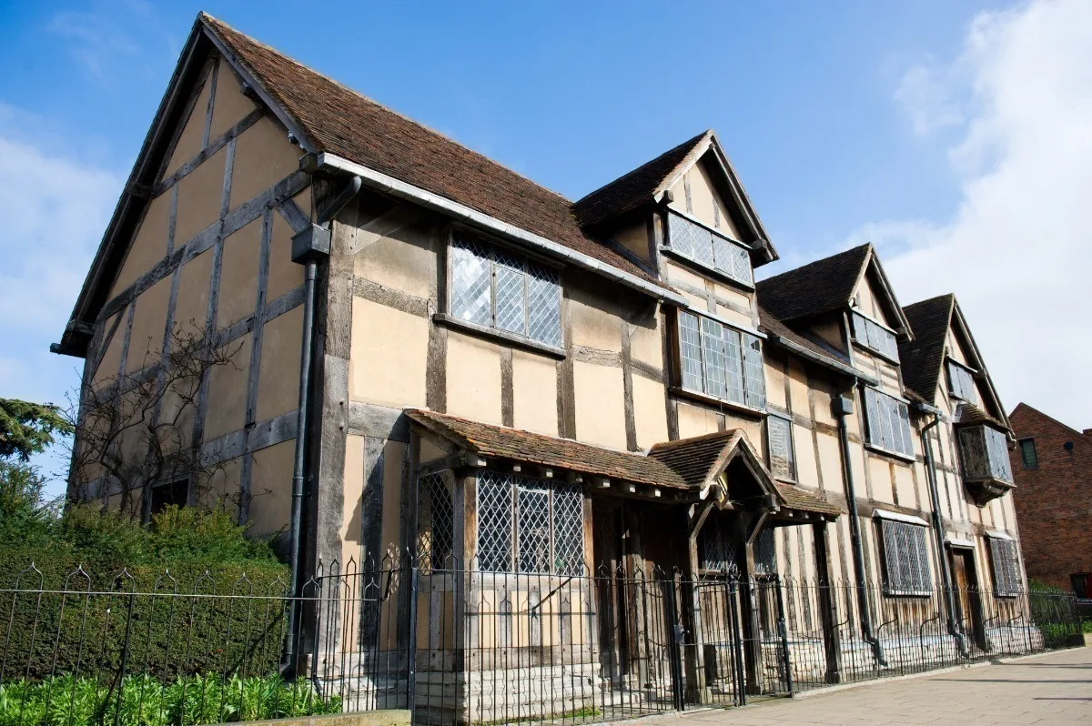 A Tudor building with external wooden beams and pointed roofs. 