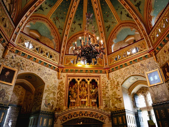 An intricately decorated chapel with a domed ceiling and chandelier. 