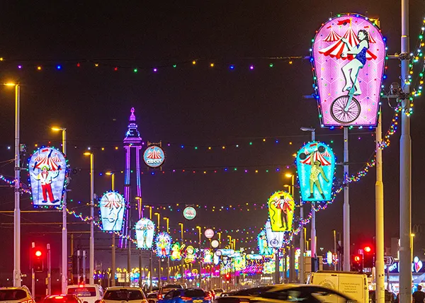 A nighttime view of Blackpool seafront with an array of multicoloured illuminations