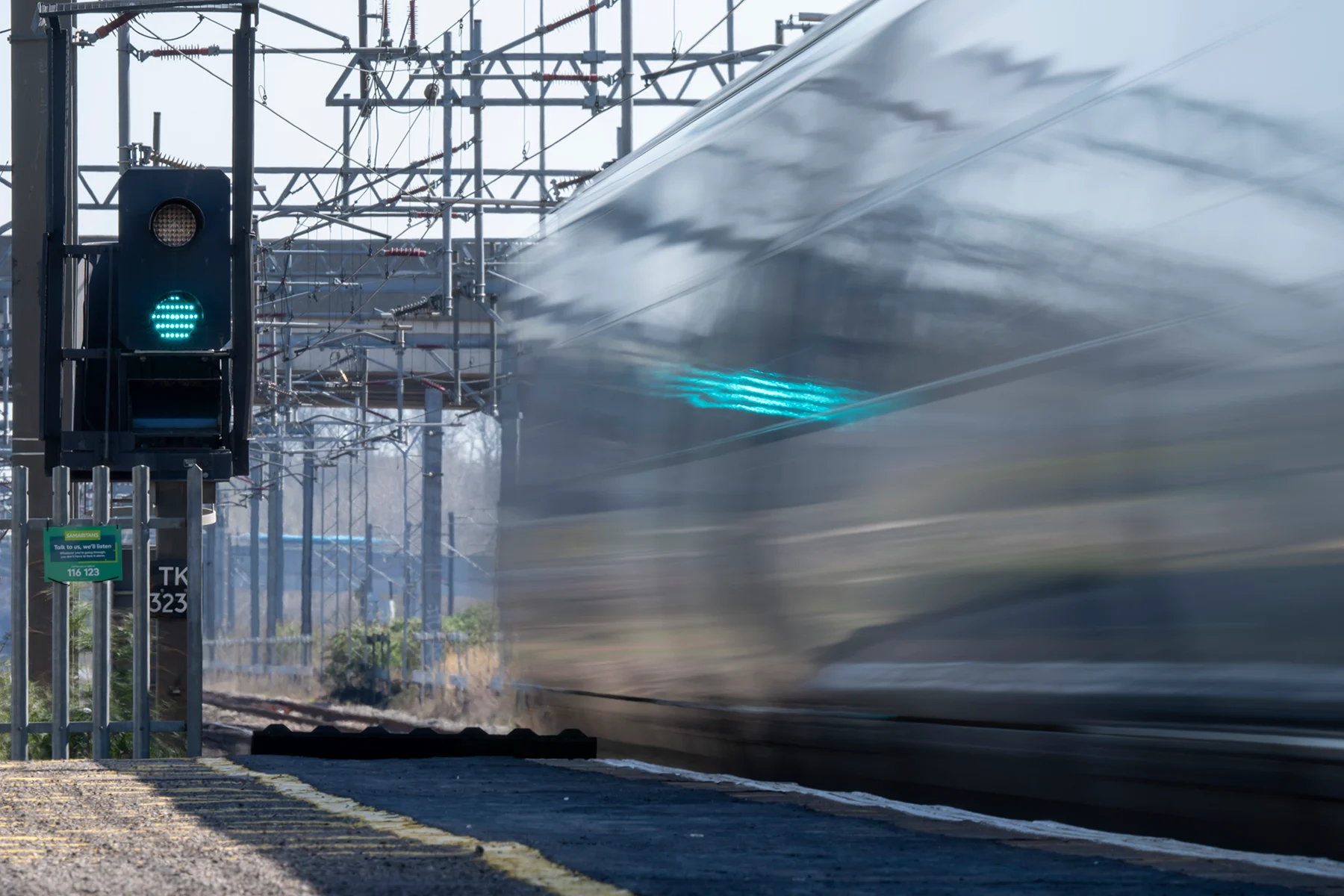 A train travelling at speed passing a green signal light