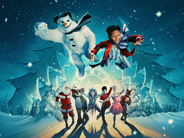 A Black boy in pyjamas and dressing gown holding hands with a Snowman and flying above fantasy Christmas characters including Santa in a magical winter scene