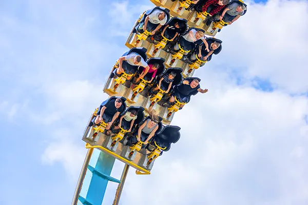 Riders descending on a giant roller coaster. 