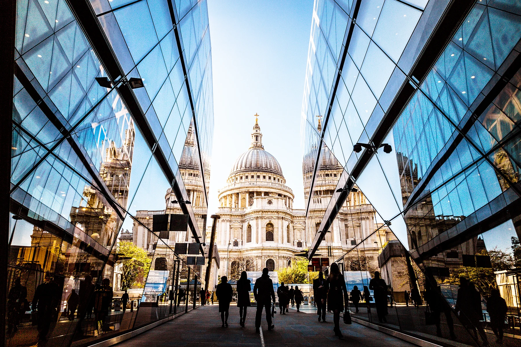 A view between two glass buildings looking towards St Pauls Cathedral.