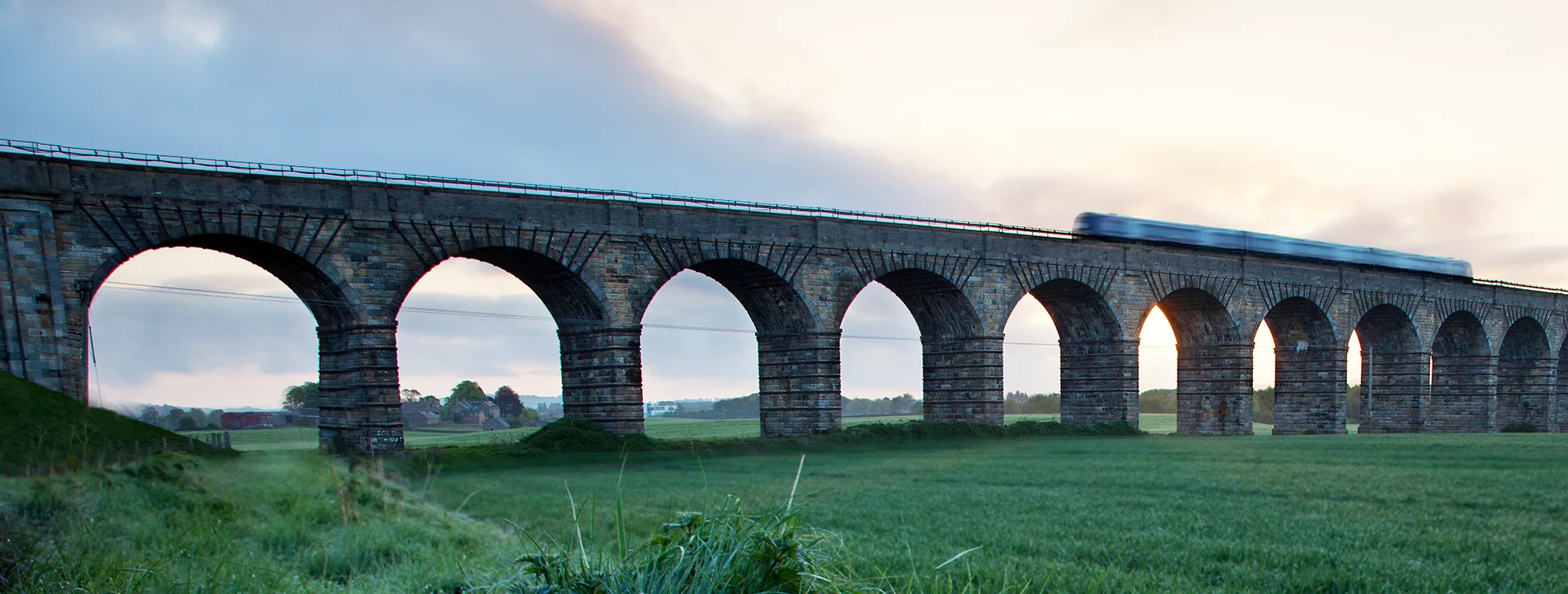 A train going over Broxburn Viaduct near Edinburgh on a clear day