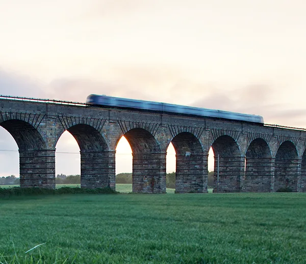 A train going over Broxburn Viaduct near Edinburgh on a clear day