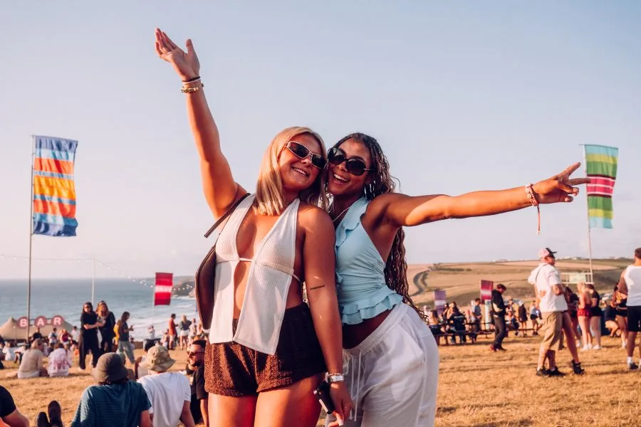 Festival goers enjoying the sunshine and atmosphere at Boardmasters festival.