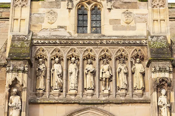 Statues of figures on the external wall of an ancient cathedral. 