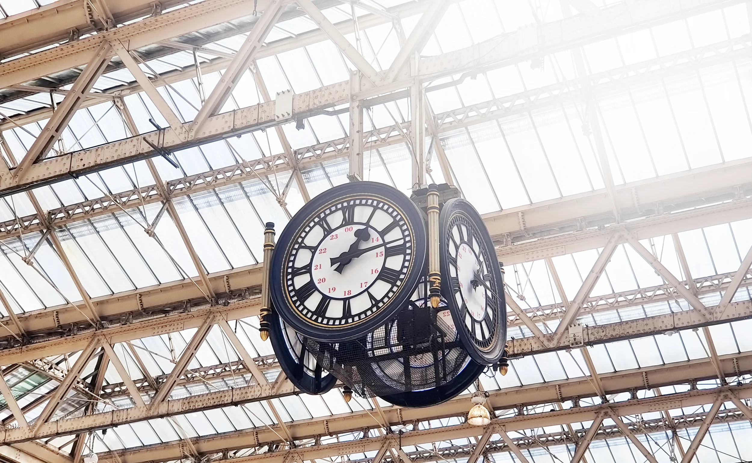 The four-faced hanging clock at Waterloo station on a sunny day
