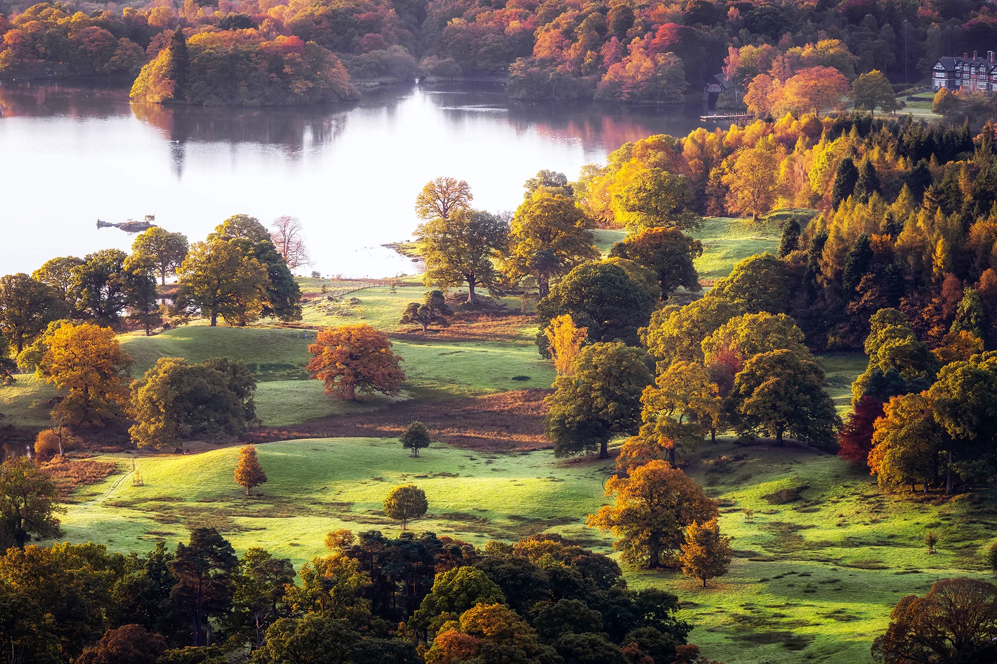 View of Lake Windermere with colourful autumn leaves on the surrounding trees