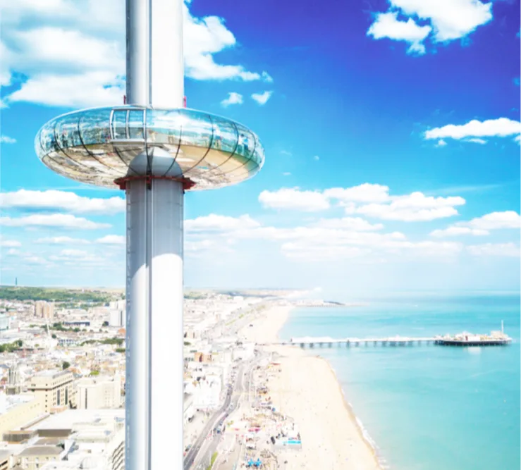 Aerial view of Brighton city, the beach and pier, with the i360 tower in the foreground. 