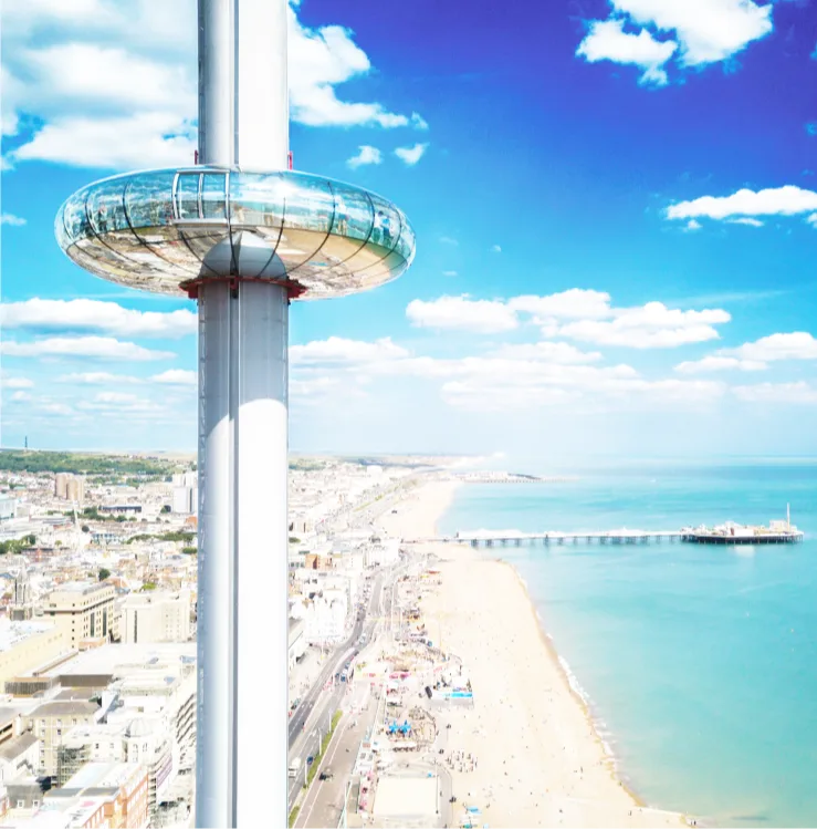 Aerial view of Brighton city, the beach and pier, with the i360 tower in the foreground. 