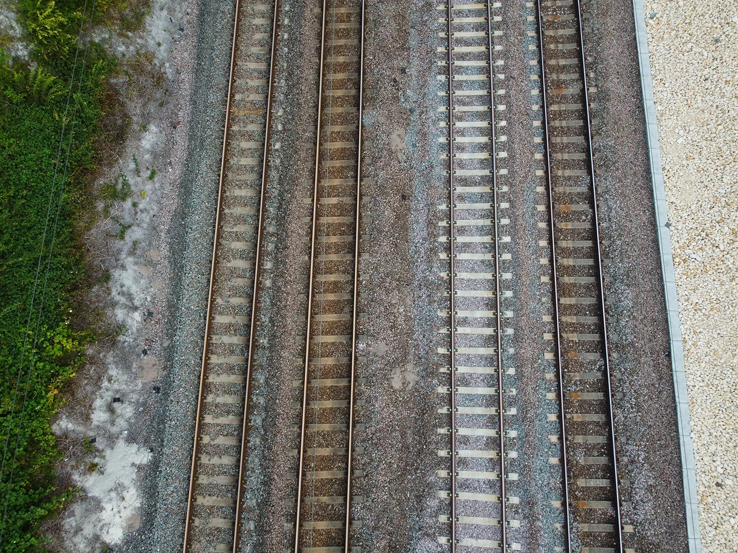 A view of multiple parallel railway tracks seen from above.