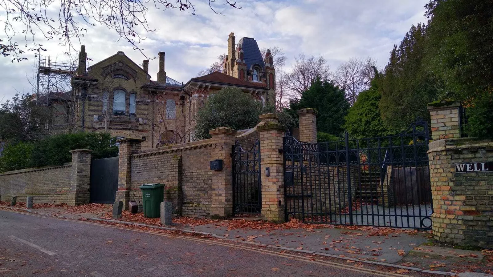 A large gated mansion on a London street. 