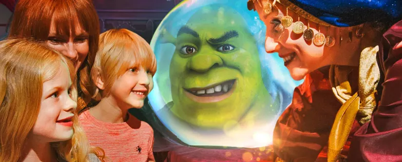 A white family and a white fortune teller smile at each other, while Shrek is visible in a crystal ball behind