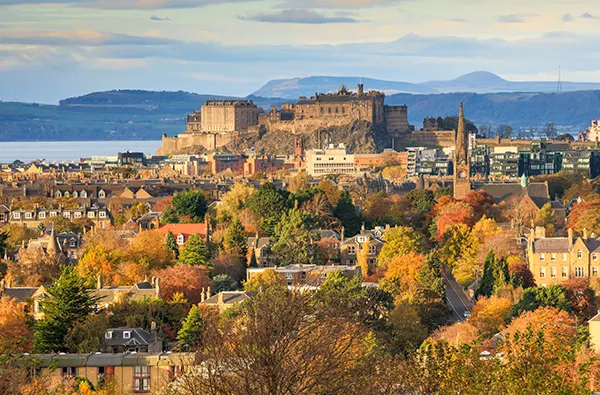 The city of Edinburgh on a sunny autumn day, looking across the city to the castle on the hill.
