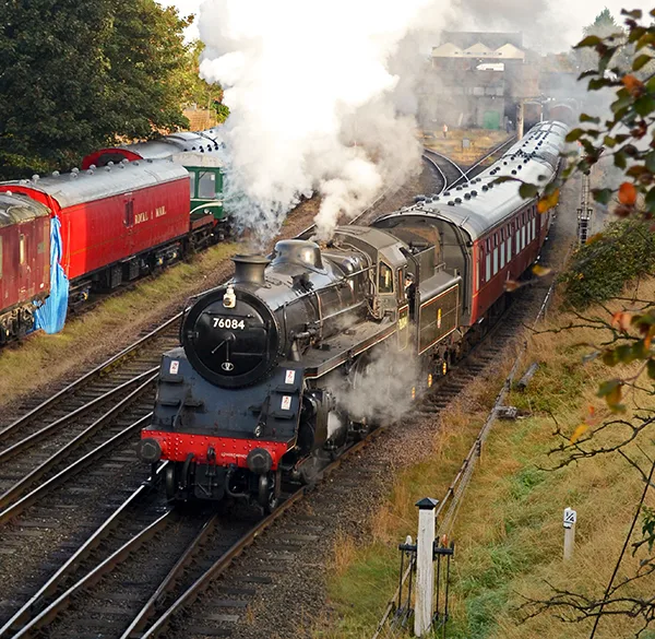 A black steam train running on tracks. 