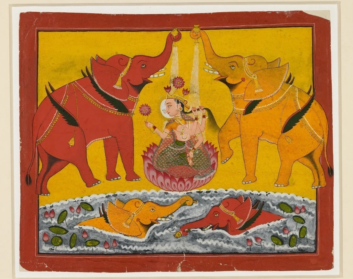 An ancient Indian illustration of a goddess with 4 arms surrounded by elephants 
