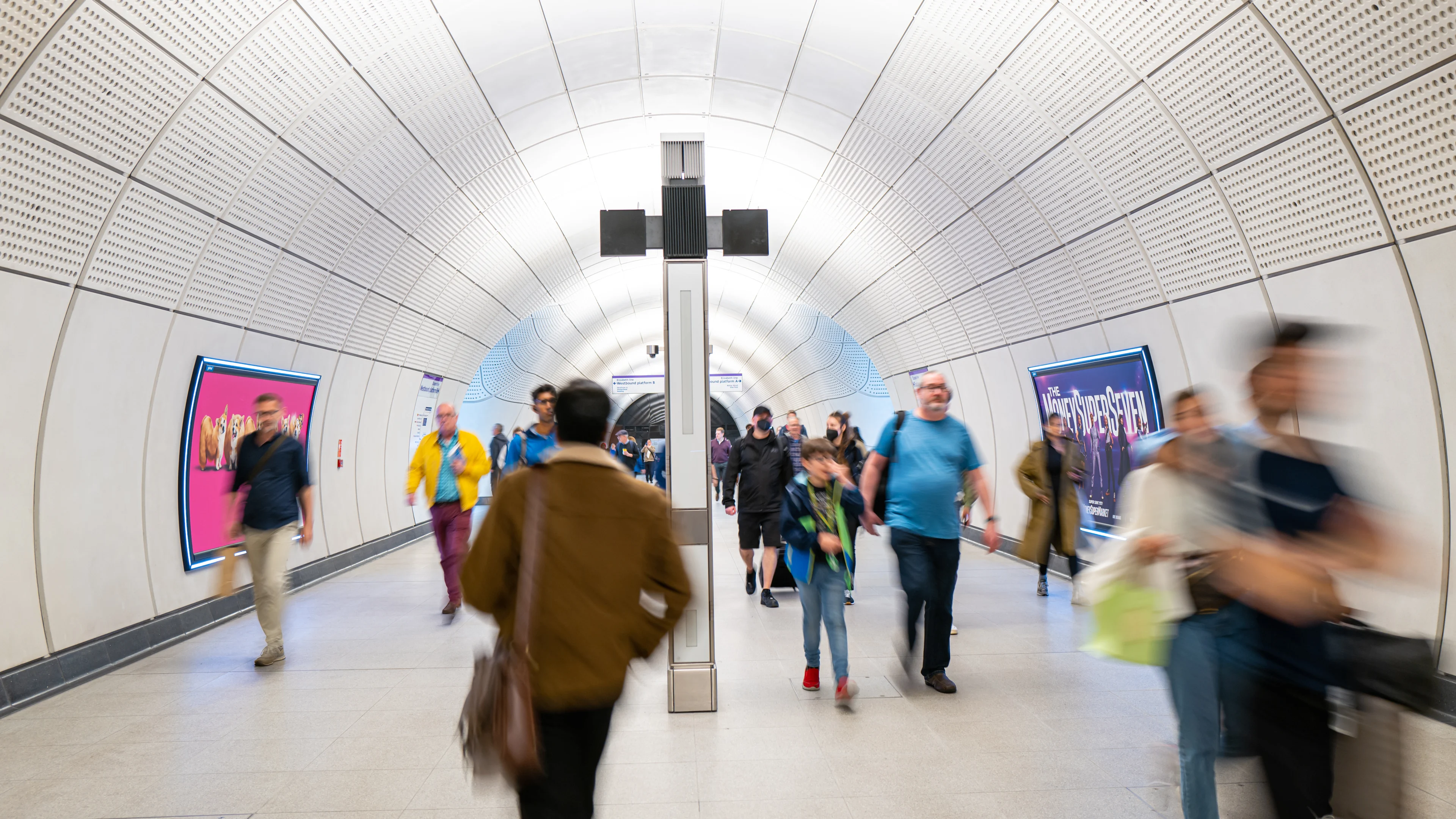 Passengers walking down a subway at Tottenham Court Road station to and from the Elizabeth line platforms.