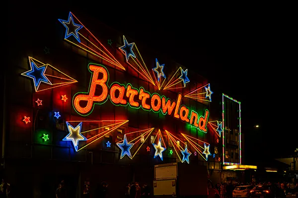 A bright neon sign that reads "Barrowland" in red letters, surrounded by blue stars.